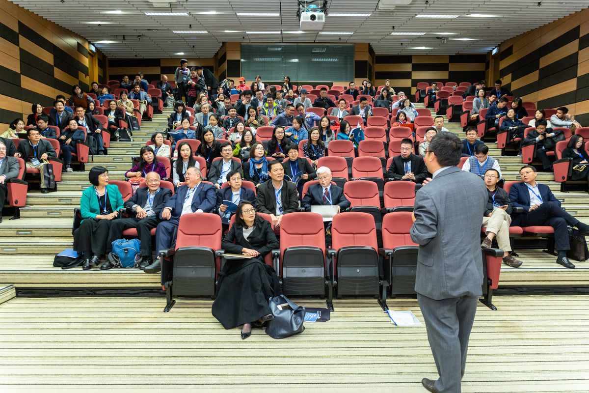 Professional setting of a business conference with attendees and a presenter