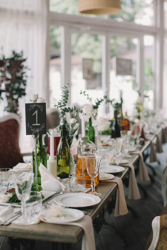 Chic dining setup with elegant tableware and floral decor.